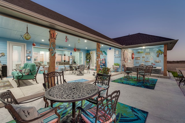 view of patio terrace at dusk