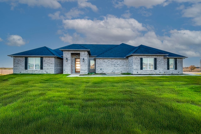 view of front of property with a front lawn and brick siding