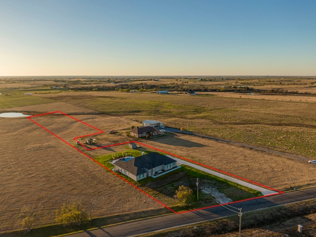 aerial view at dusk featuring a rural view