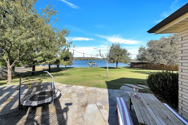 view of yard featuring a water view and a patio area