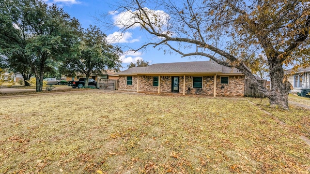 rear view of property featuring a lawn