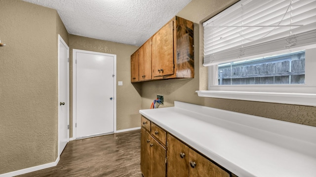 kitchen featuring a textured ceiling and dark wood-type flooring