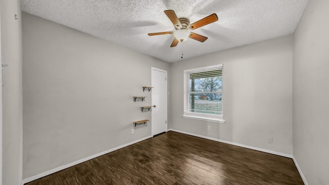 empty room with dark wood-type flooring, a textured ceiling, and ceiling fan