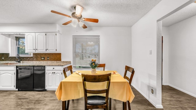 dining room with a textured ceiling, dark hardwood / wood-style floors, ceiling fan, and sink