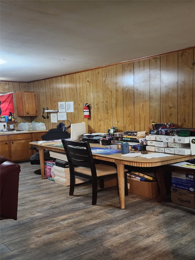 dining area featuring wood walls and dark hardwood / wood-style floors