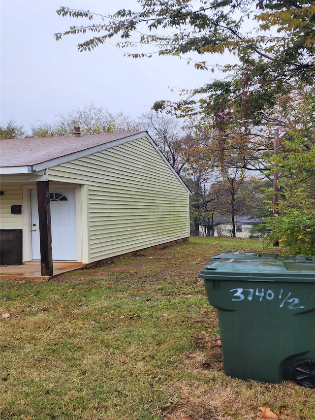 view of side of home with a yard