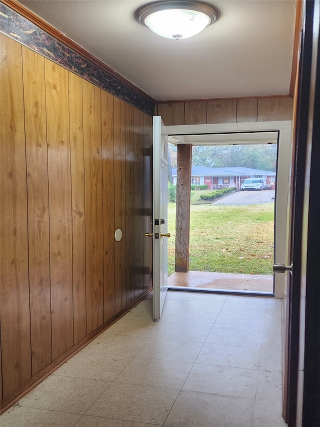 entryway with wood walls