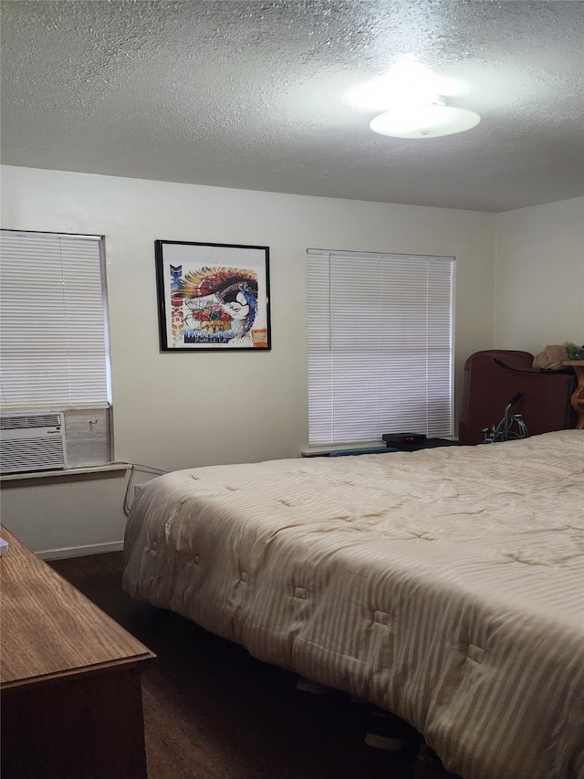 bedroom with cooling unit and a textured ceiling