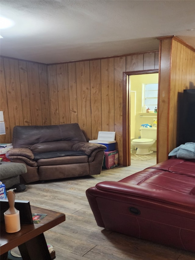 living room featuring hardwood / wood-style flooring and wooden walls