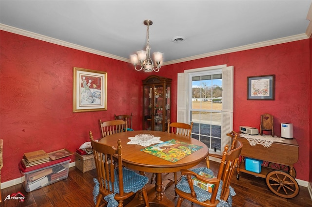 dining room with ornamental molding, dark hardwood / wood-style flooring, and a notable chandelier