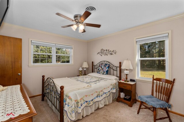 carpeted bedroom with crown molding and ceiling fan