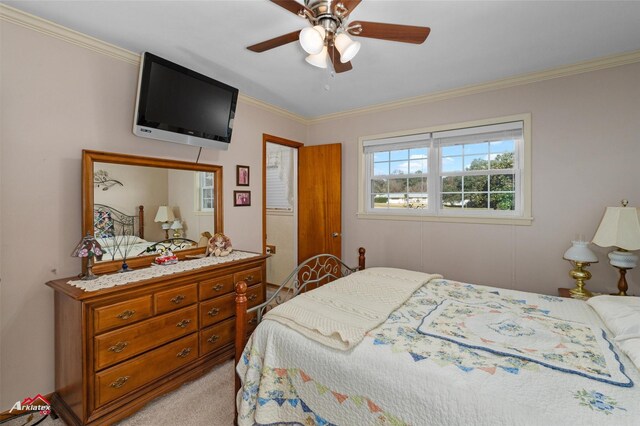 carpeted bedroom with crown molding and ceiling fan