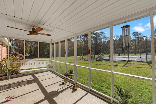 unfurnished sunroom with ceiling fan