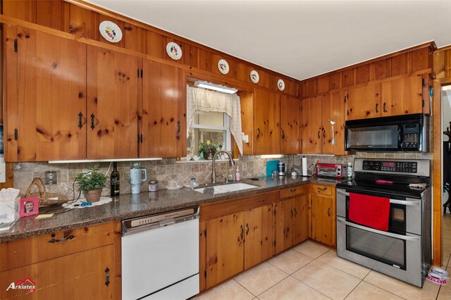 kitchen with tasteful backsplash, double oven range, sink, and white dishwasher