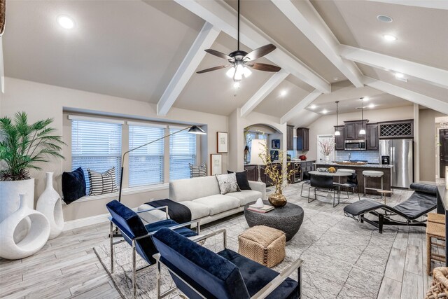 kitchen with decorative backsplash, stainless steel appliances, sink, a center island with sink, and vaulted ceiling with beams