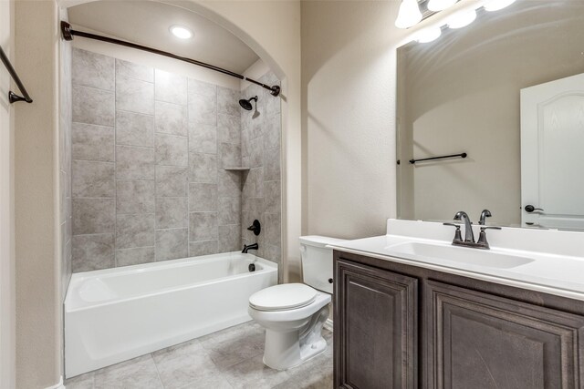 full bathroom with tile patterned flooring, toilet, vanity, and tiled shower / bath