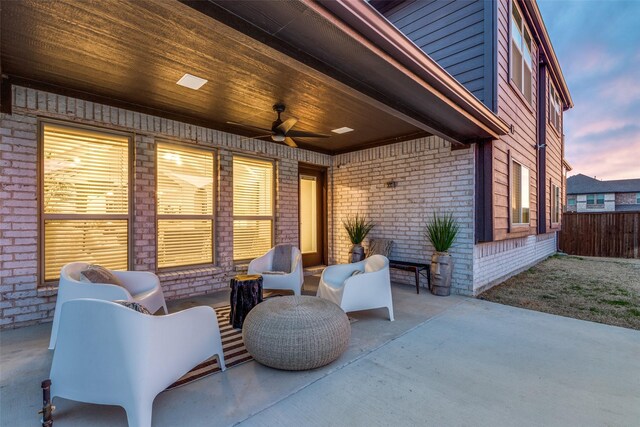 patio terrace at dusk featuring outdoor lounge area and ceiling fan