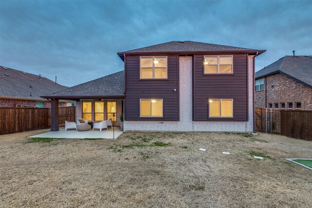 rear view of house featuring an outdoor living space and a patio area