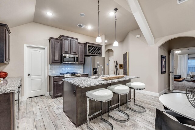 foyer entrance featuring an inviting chandelier, light hardwood / wood-style flooring, and a tray ceiling