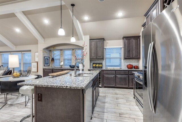 interior space with an inviting chandelier, light hardwood / wood-style flooring, and vaulted ceiling