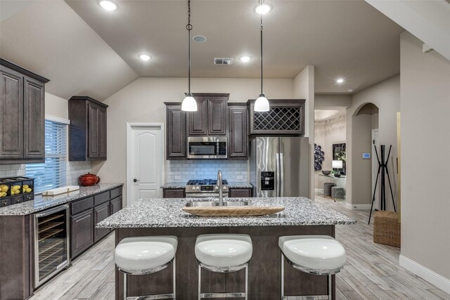 living room with ceiling fan, beamed ceiling, light hardwood / wood-style floors, and high vaulted ceiling