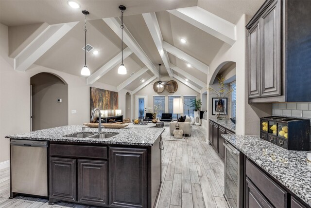 living room featuring vaulted ceiling with beams, light hardwood / wood-style floors, and ceiling fan