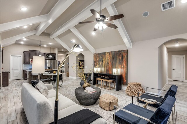 living room with vaulted ceiling with beams, light hardwood / wood-style flooring, and ceiling fan