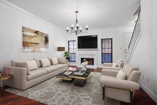 living room featuring a chandelier, hardwood / wood-style floors, and ornamental molding