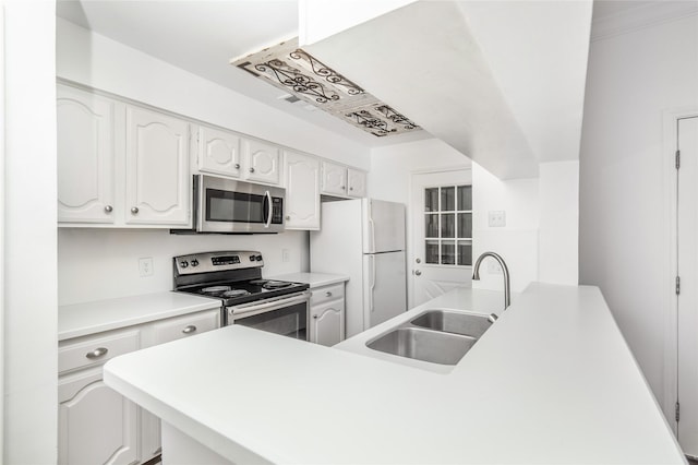 kitchen featuring appliances with stainless steel finishes, white cabinetry, and sink