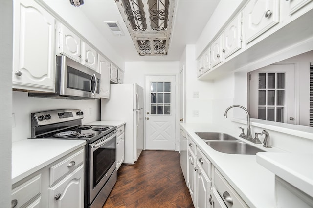 kitchen with white cabinets, dark hardwood / wood-style flooring, stainless steel appliances, and sink