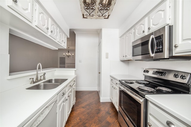 kitchen featuring sink, dark hardwood / wood-style floors, appliances with stainless steel finishes, white cabinetry, and a chandelier