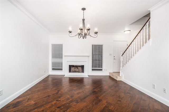 unfurnished living room with dark hardwood / wood-style flooring, ornamental molding, and a chandelier