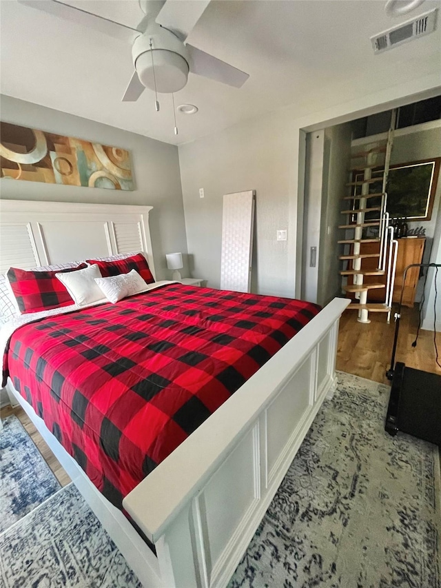 bedroom with hardwood / wood-style flooring and ceiling fan