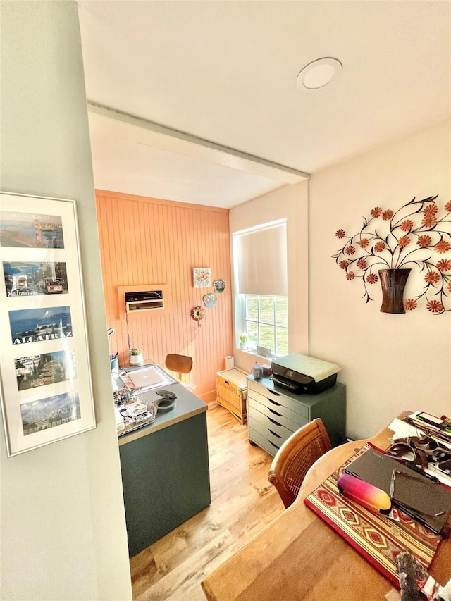 bedroom with wooden walls and light wood-type flooring