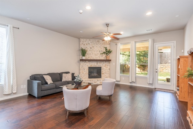 living room featuring a fireplace, dark hardwood / wood-style floors, and ceiling fan