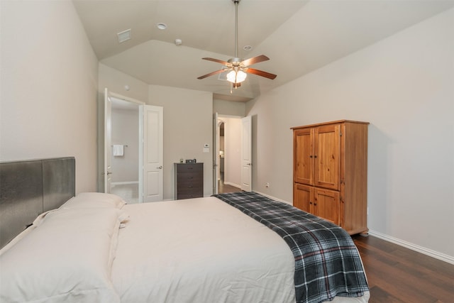 bedroom with ceiling fan, dark hardwood / wood-style flooring, lofted ceiling, and connected bathroom