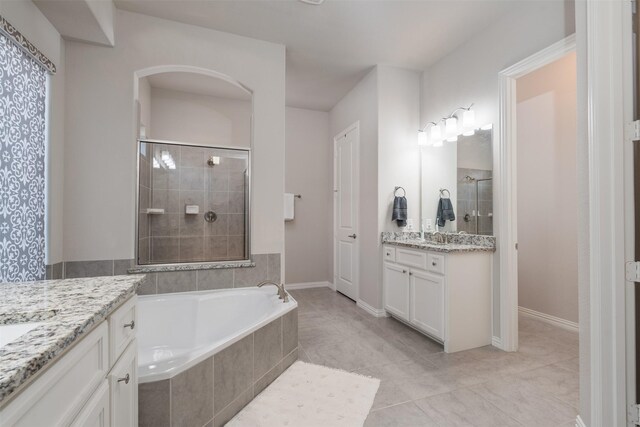 bathroom featuring plus walk in shower and vanity