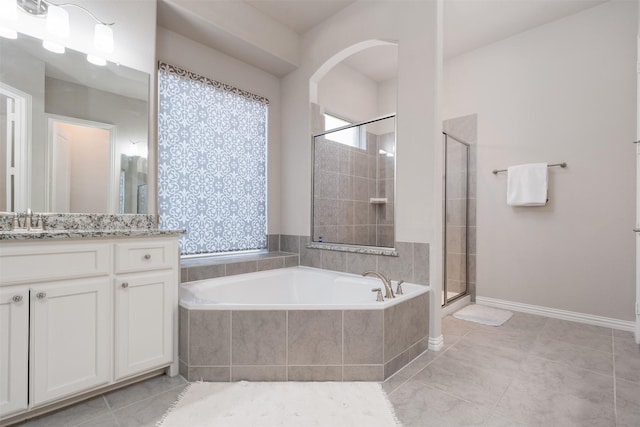 bathroom featuring tile patterned flooring, vanity, and separate shower and tub