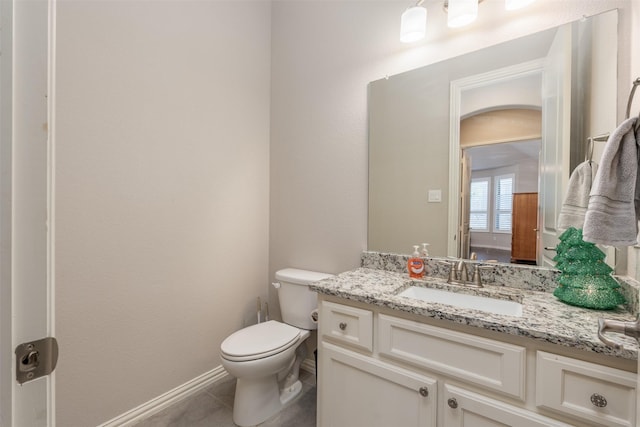 bathroom featuring tile patterned flooring, vanity, and toilet