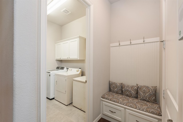 clothes washing area with washing machine and dryer