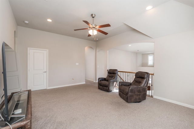 living area featuring ceiling fan and carpet