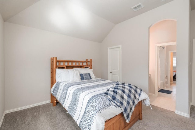 bedroom with carpet flooring and lofted ceiling