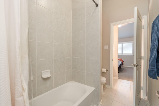 bathroom featuring toilet, tile patterned floors, and shower / bath combo with shower curtain