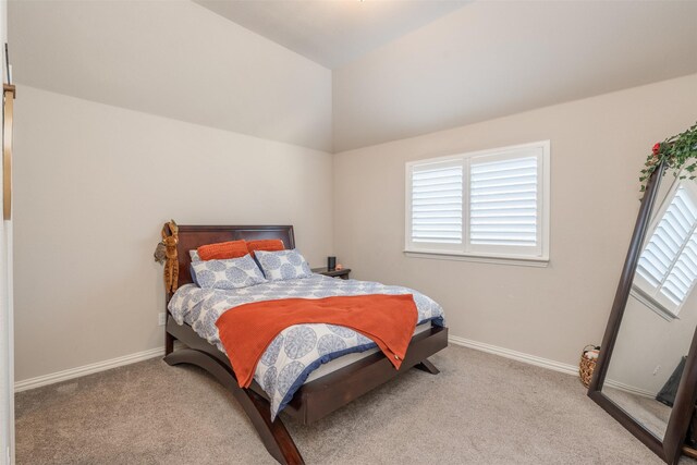 carpeted bedroom with vaulted ceiling