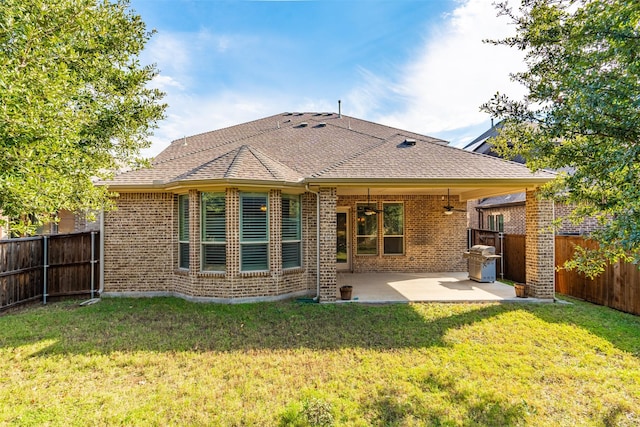 back of property featuring a patio area, ceiling fan, and a yard