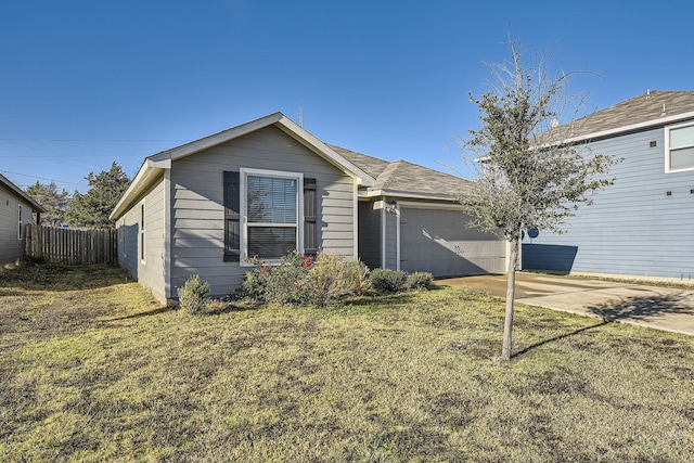 view of front of property featuring a garage and a front lawn