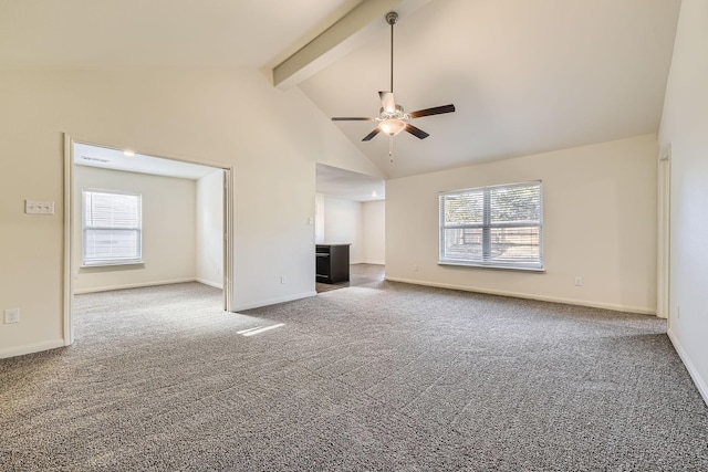 unfurnished living room with carpet, ceiling fan, a healthy amount of sunlight, and beam ceiling