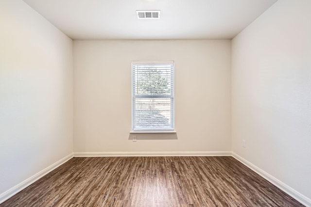 unfurnished room with dark hardwood / wood-style floors