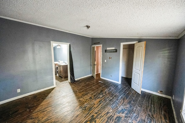 unfurnished bedroom featuring a textured ceiling, dark wood-type flooring, connected bathroom, and vaulted ceiling