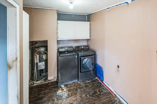 laundry area featuring electric water heater, cabinets, a textured ceiling, and independent washer and dryer